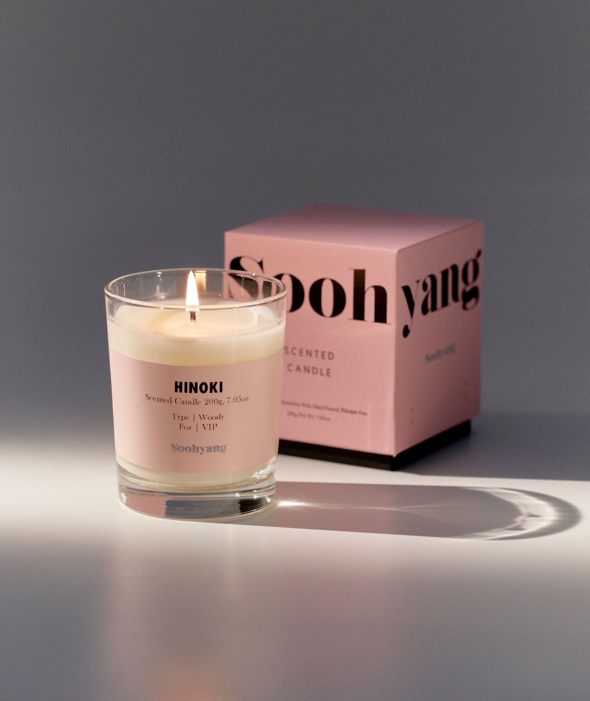 Scented candle with a pink label and 'Soohyang' box on a gray background